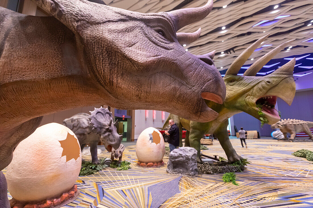 Workers assembling dinosaurs for Detroit Auto Show, USA