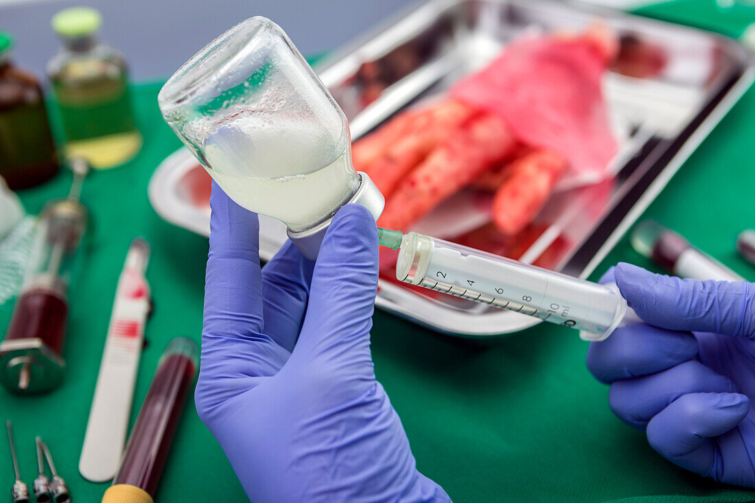 Nurse filling syringe with medication, conceptual image