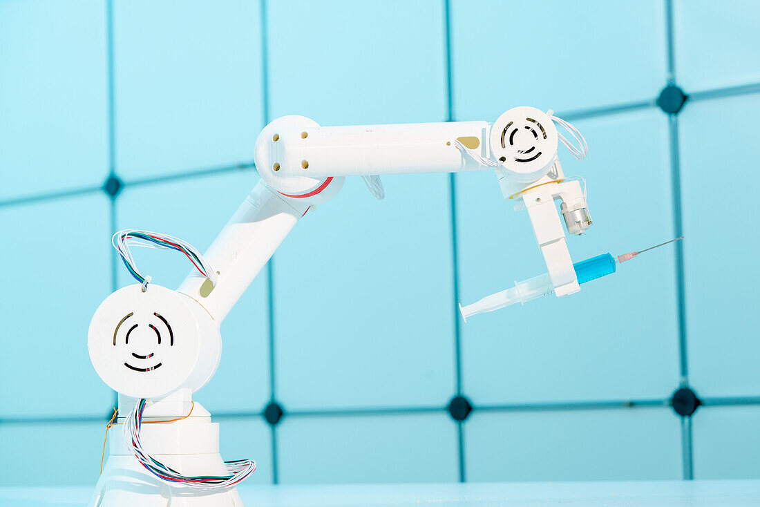 Robotic arm holding syringe