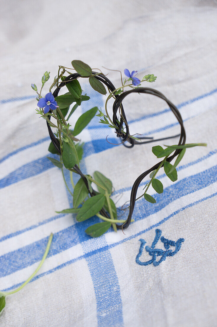 Wire heart with speedwell (Veronica) on linen fabric