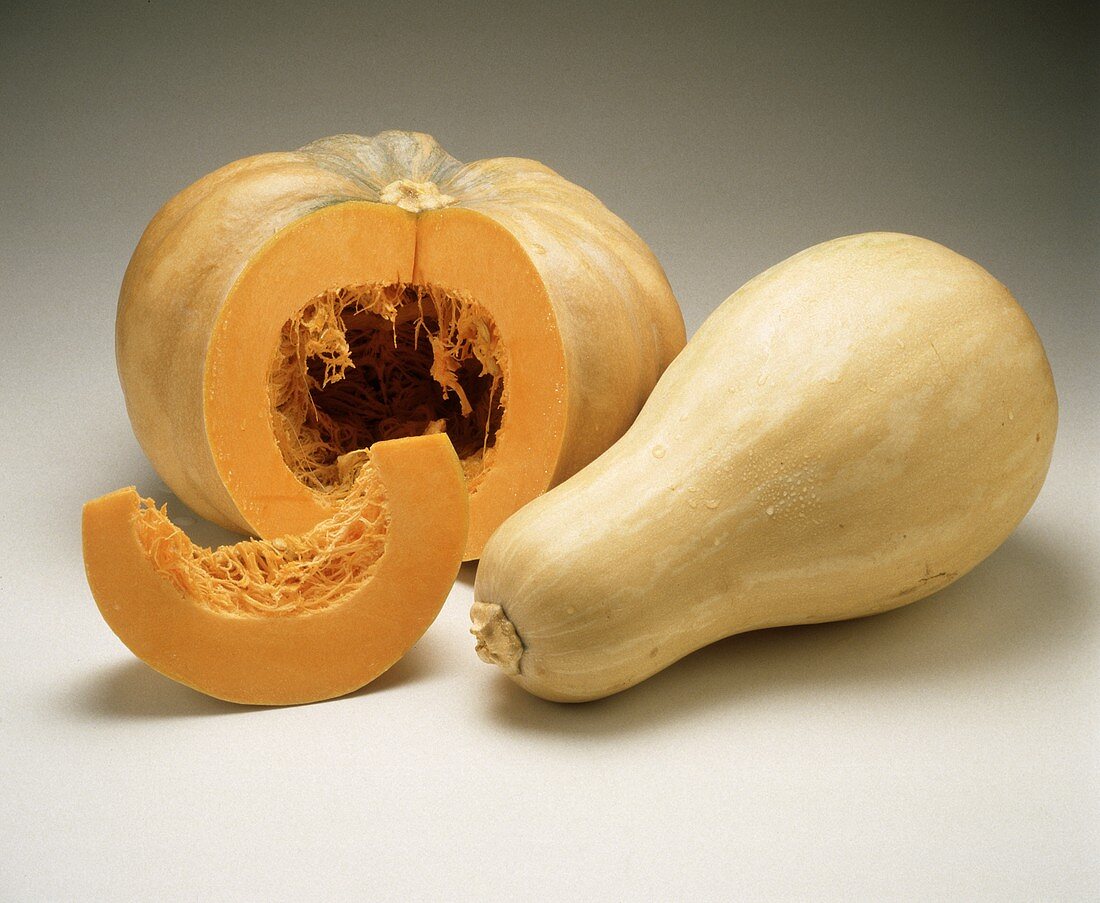A giant pumpkin, cut open, and a butternut squash