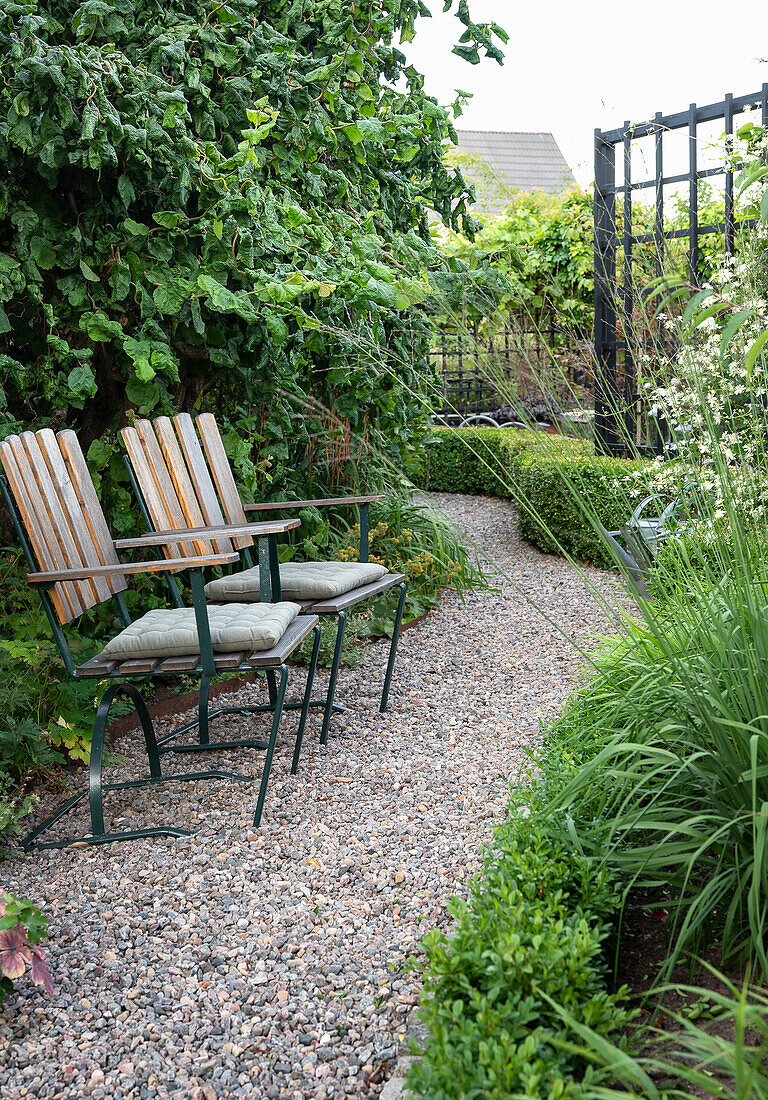 Seating area on gravel path in the garden