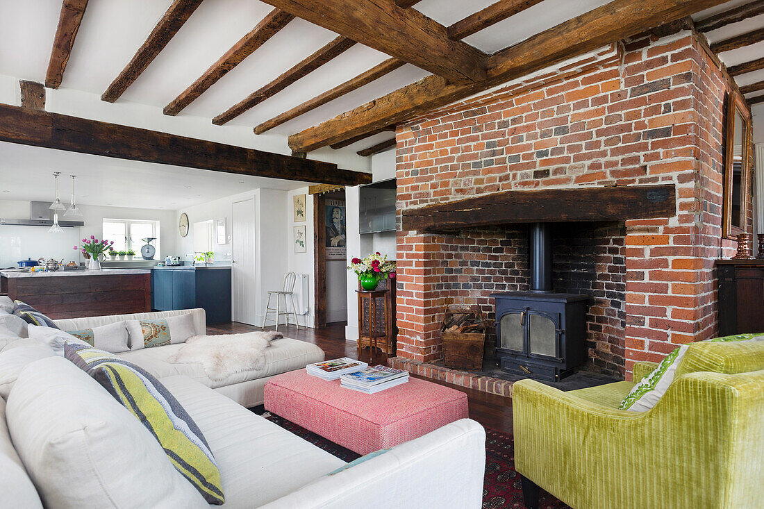 Cozy seating area in front of rustic fireplace with red bricks