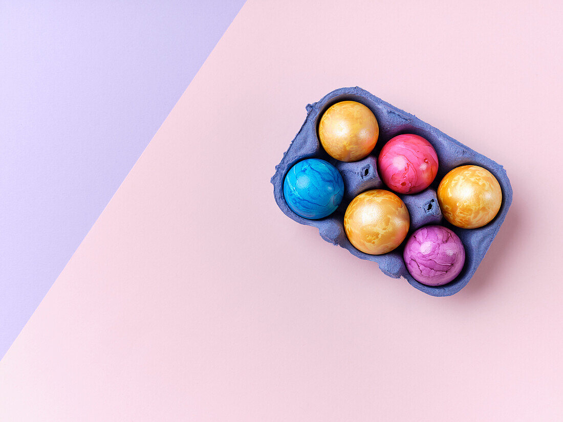 Flat lay with colored easter eggs on bright background