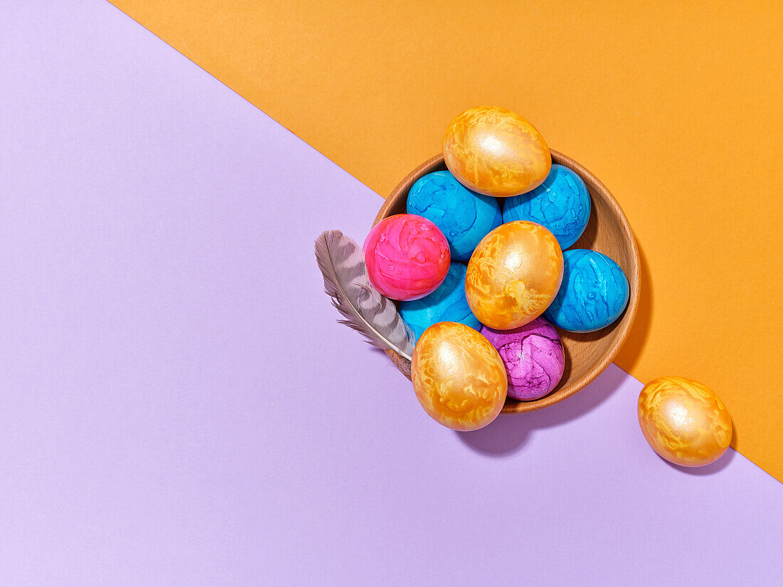 Creative layout with colored easter eggs on bright background