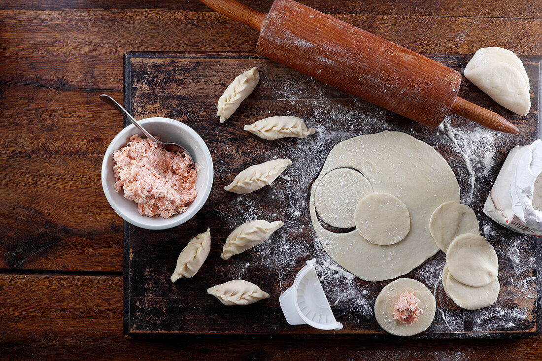 Fresh dough for dumplings with salmon filling