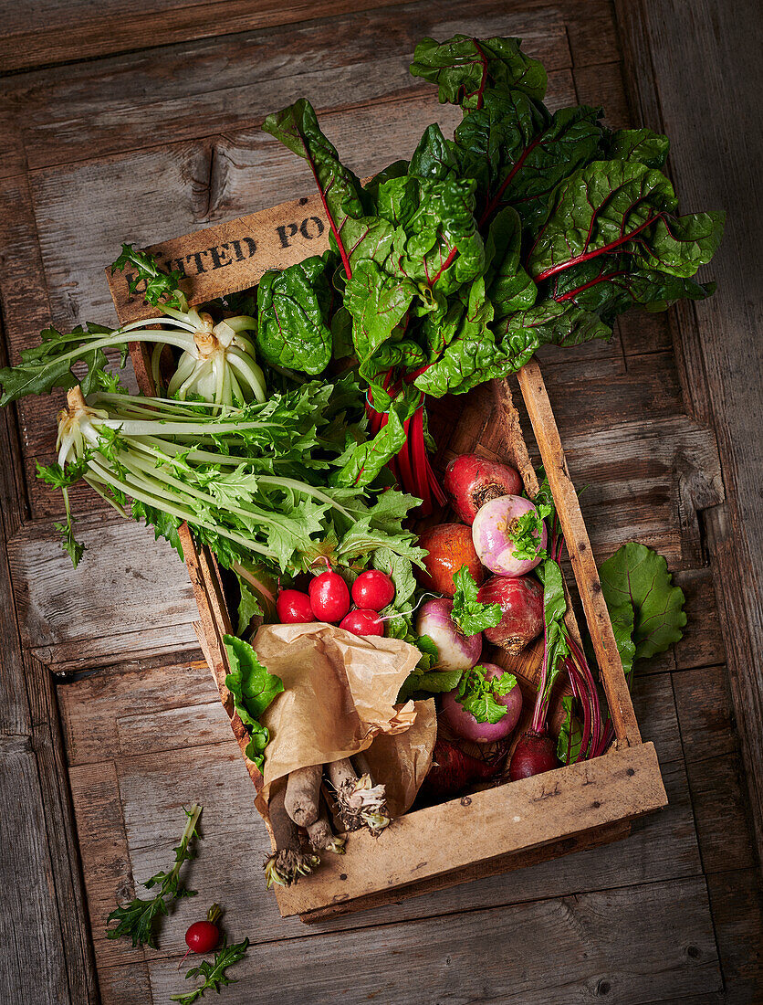 Assorted regional vegetables in wooden box
