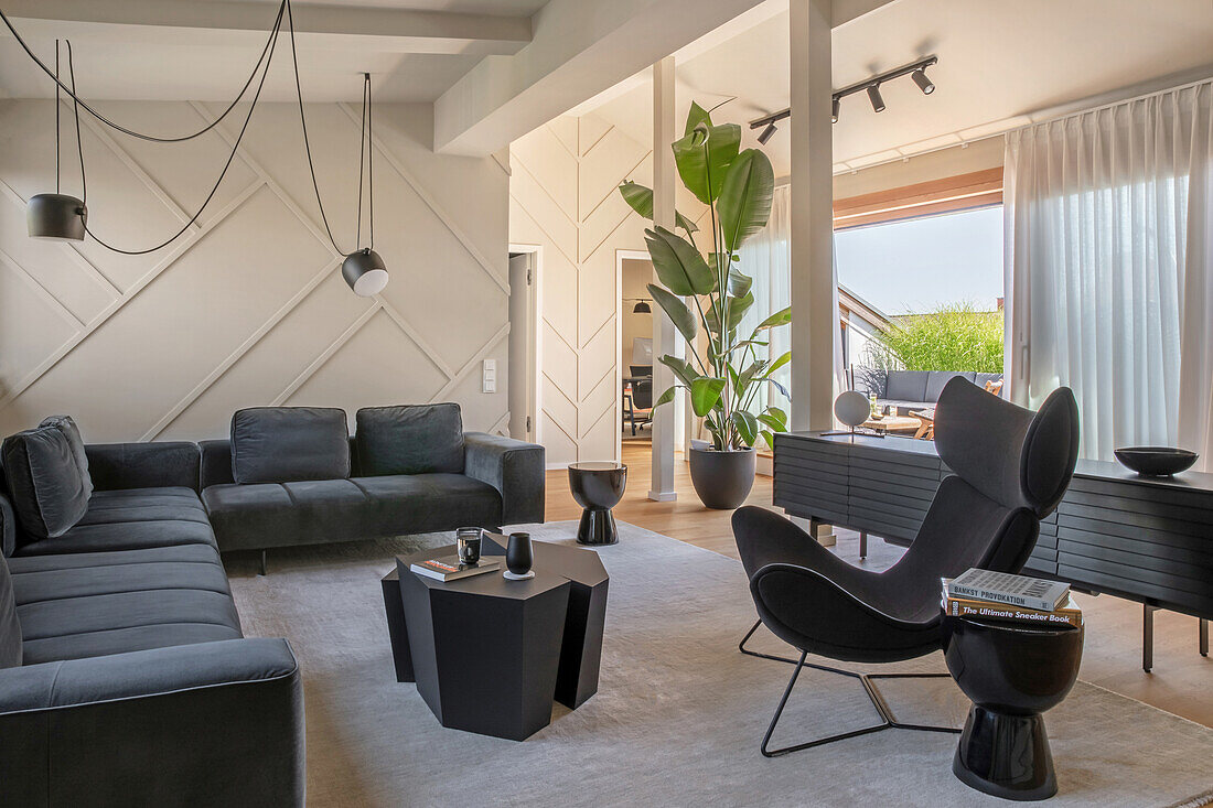 Elegant living room with dark sofa set, black coffee table and classic lounge chair