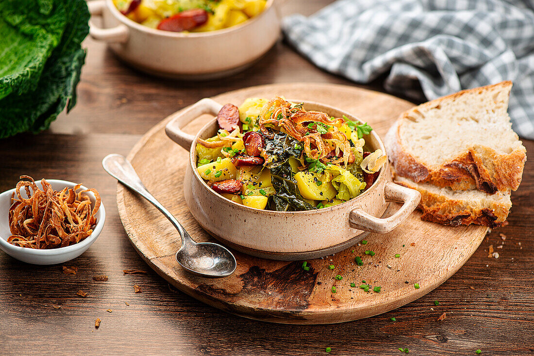 Savoy cabbage stew with smoked sausages and roasted onions