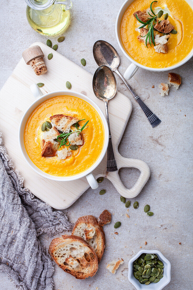 Sweet potato soup with crusty bread and pumpkin seeds