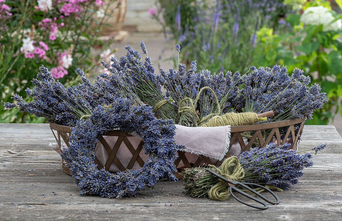 Lavendelkranz und Lavendelsträußchen in Korb auf Holztisch