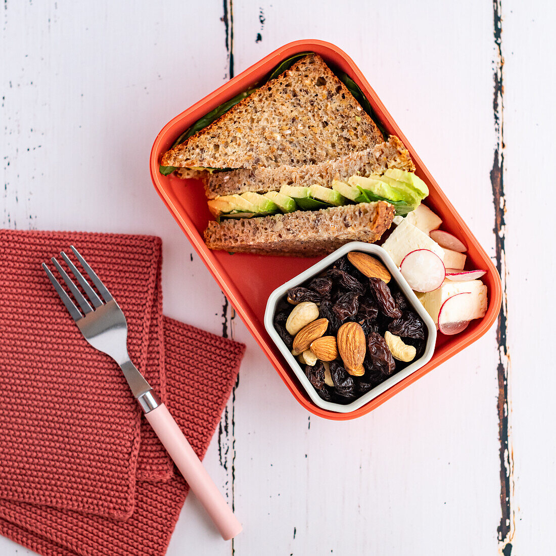 Sandwich, radish and trail mix in lunch box