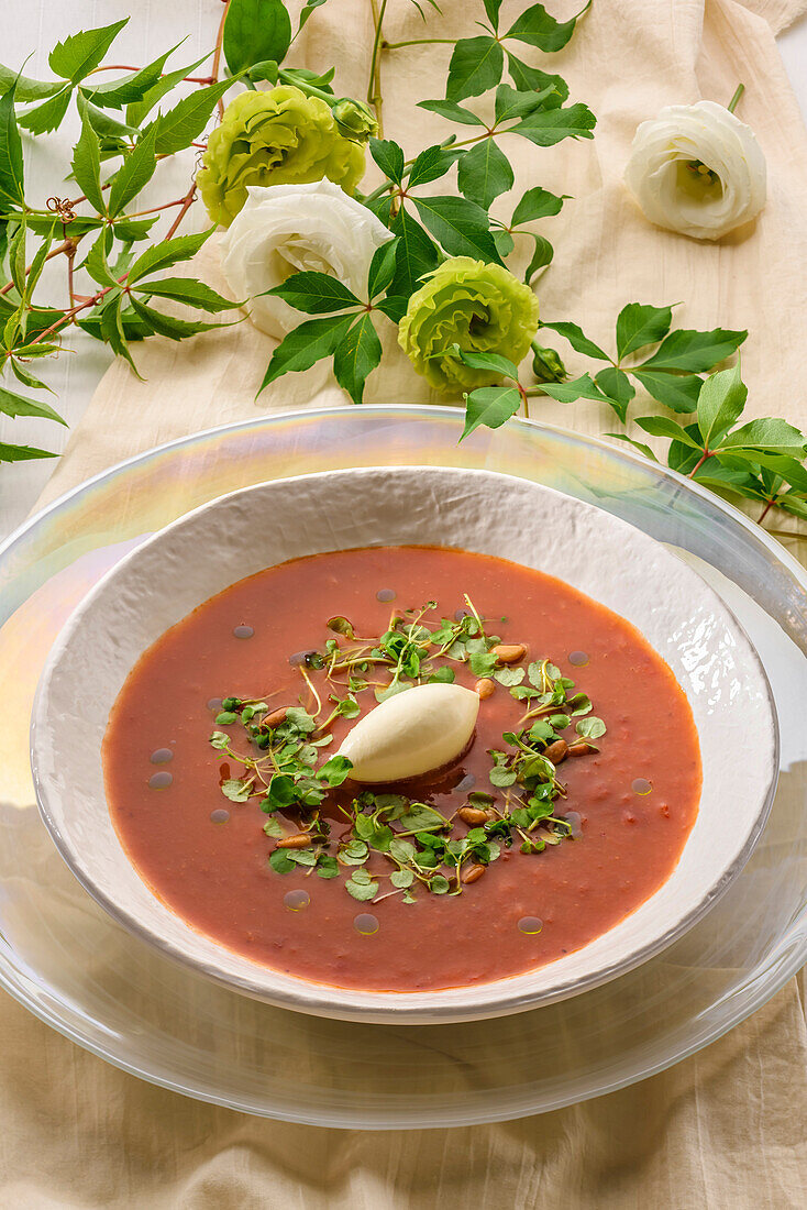 Cream of tomato soup with goat cheese and herb salad