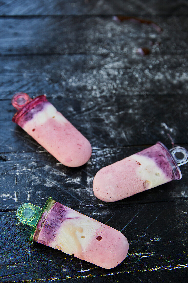 Homemade berry yogurt ice cream on a Popsicle stick