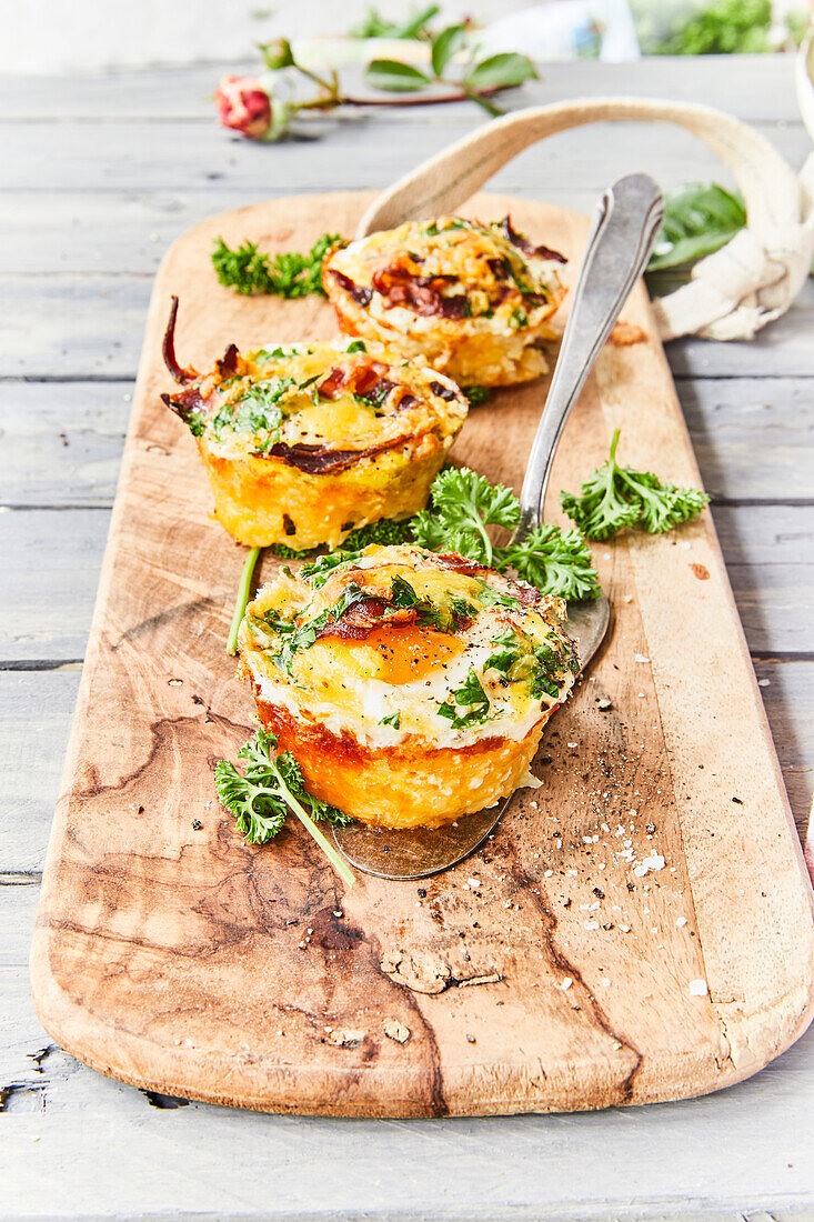 Potato nest muffins with egg served on a wooden board