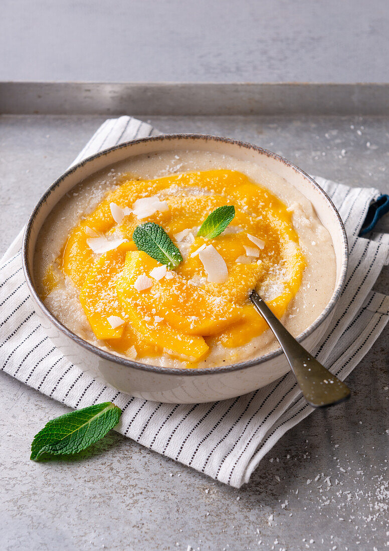 Vegan coconut spelt porridge with mango puree