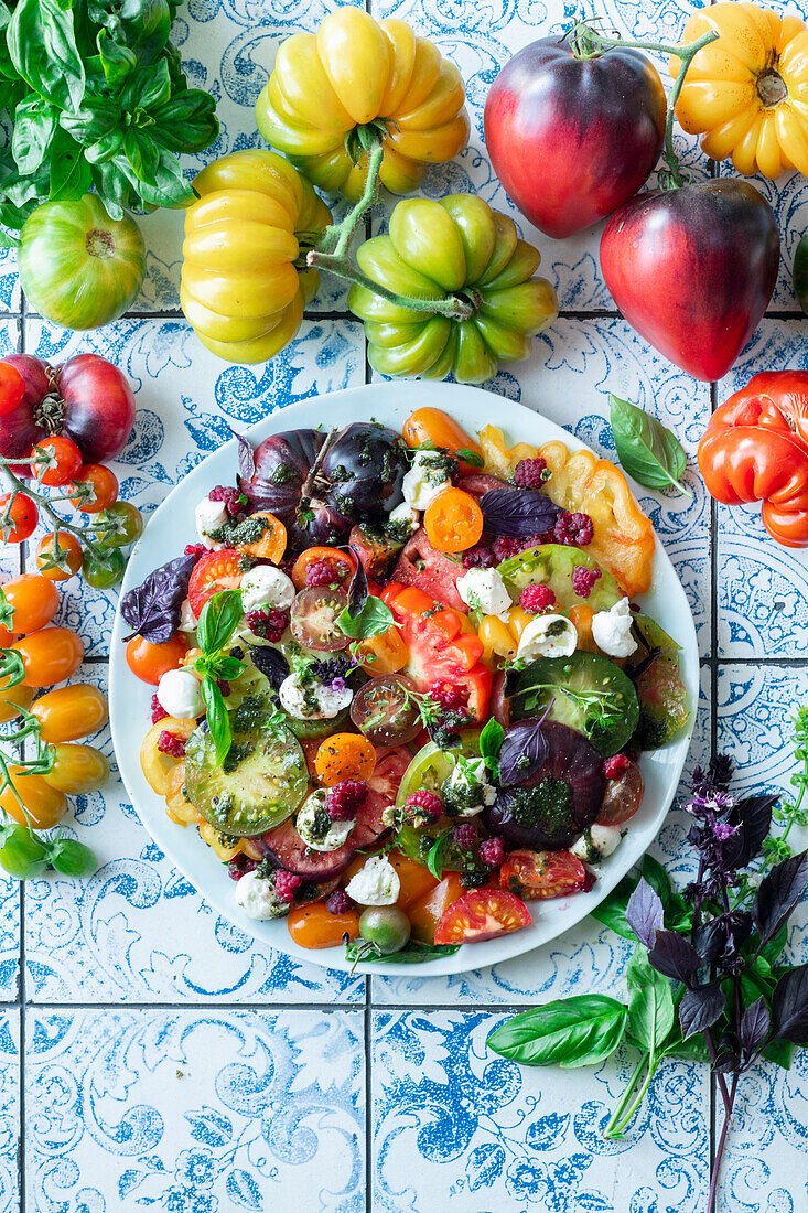 Colourful tomato and raspberry salad with mozzarella
