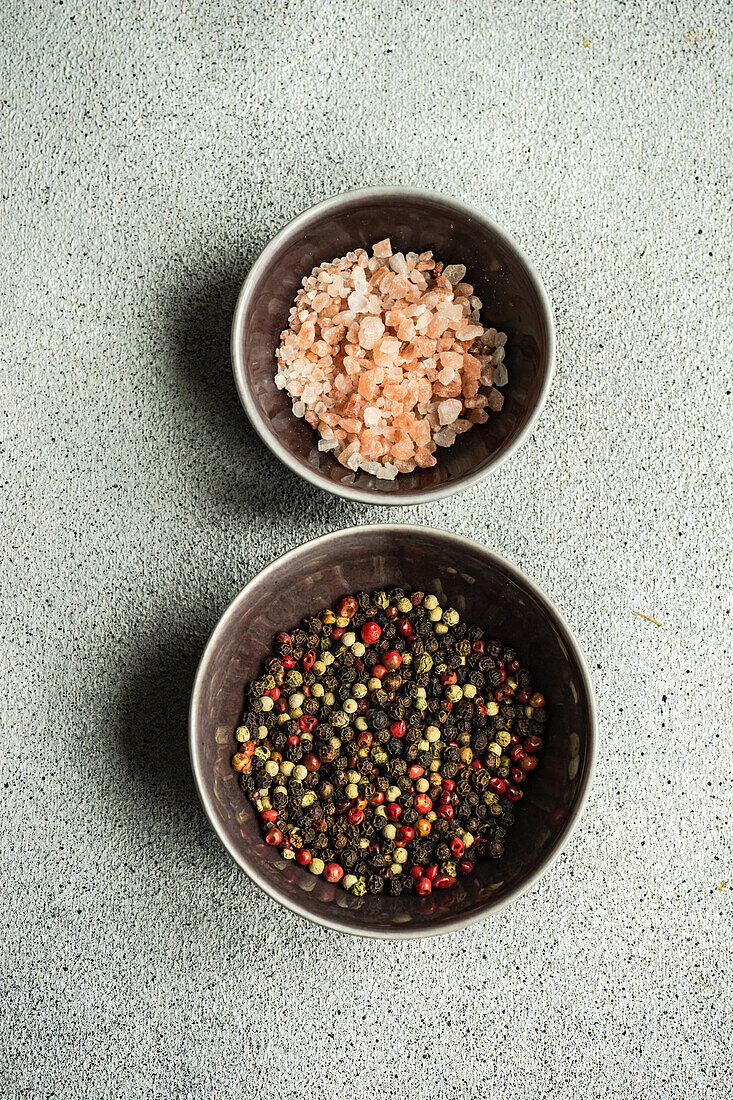 Bowl with pepper spice mix on grey concrete table