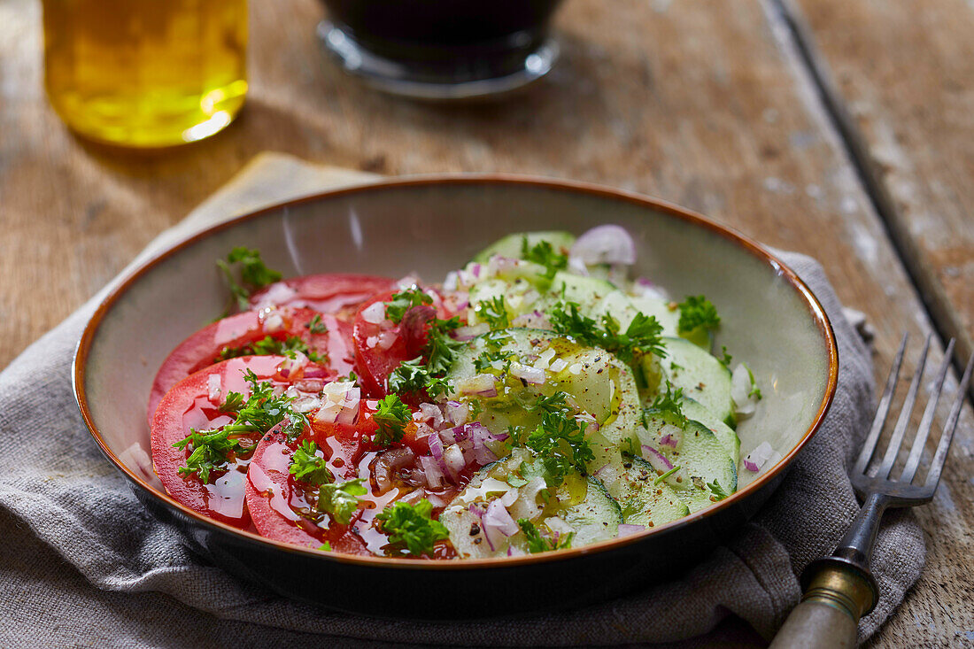Cucumber salad with tomatoes, onions and parsley