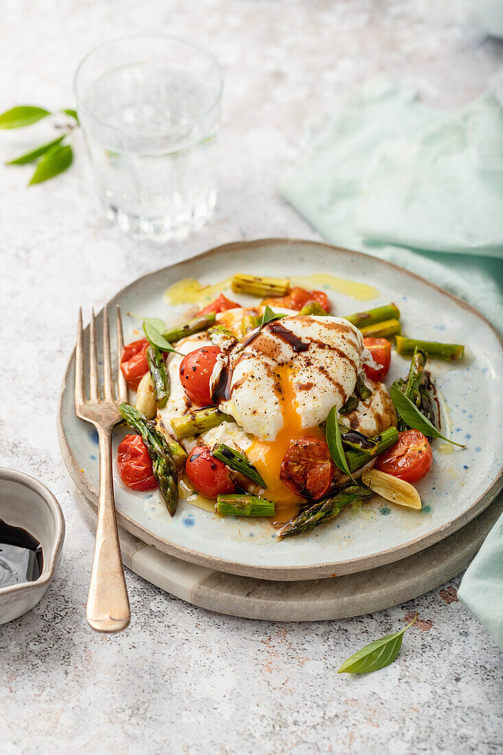 Burrata on grilled asparagus, cherry tomatoes, and garlic with balsamic vinegar