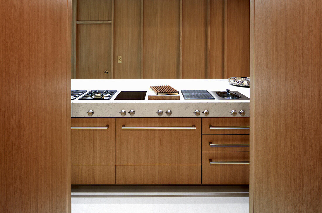 Designer kitchen with wooden cabinets and stone countertop