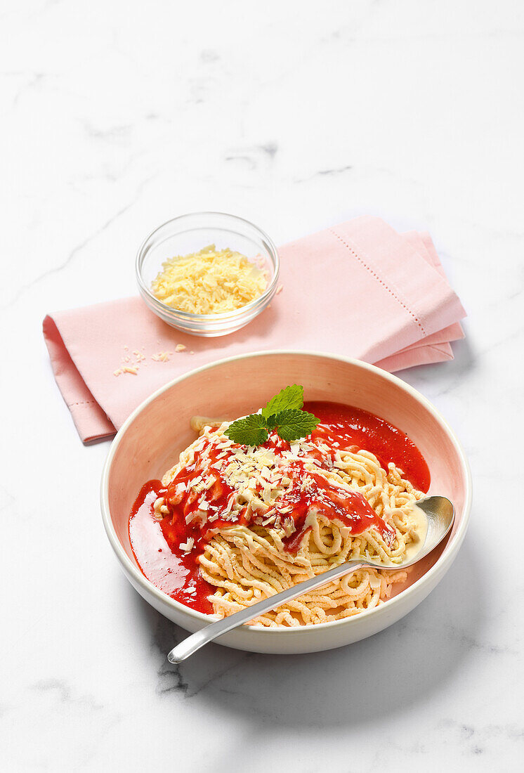 Spaghetti ice cream with berry sauce
