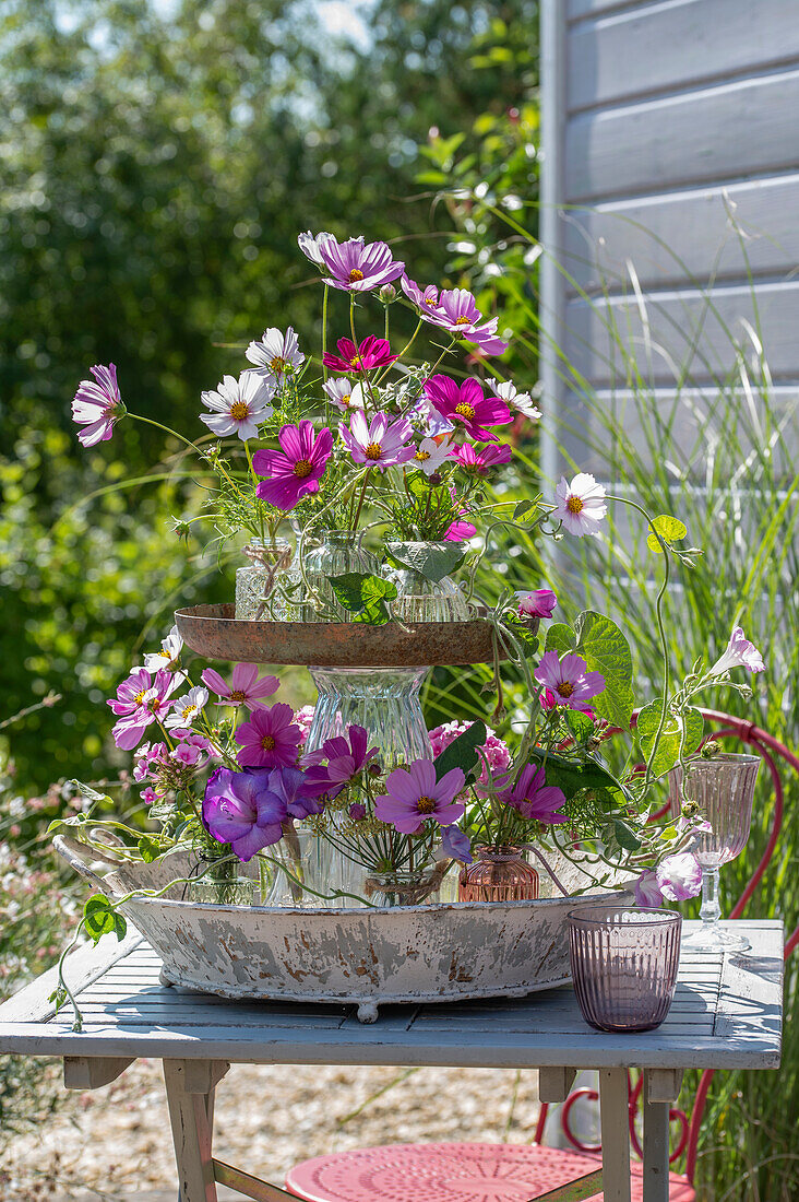Flower etagere with ornamental basket, gladioli and showy bindweed