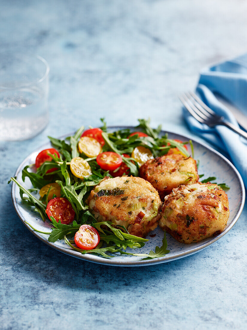 Bean and cheese patties with arugula and tomato salad