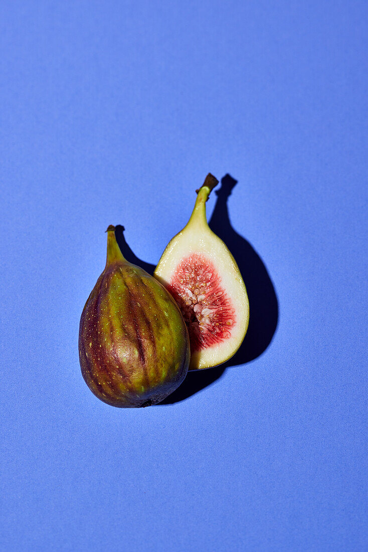 Halved fig on blue background