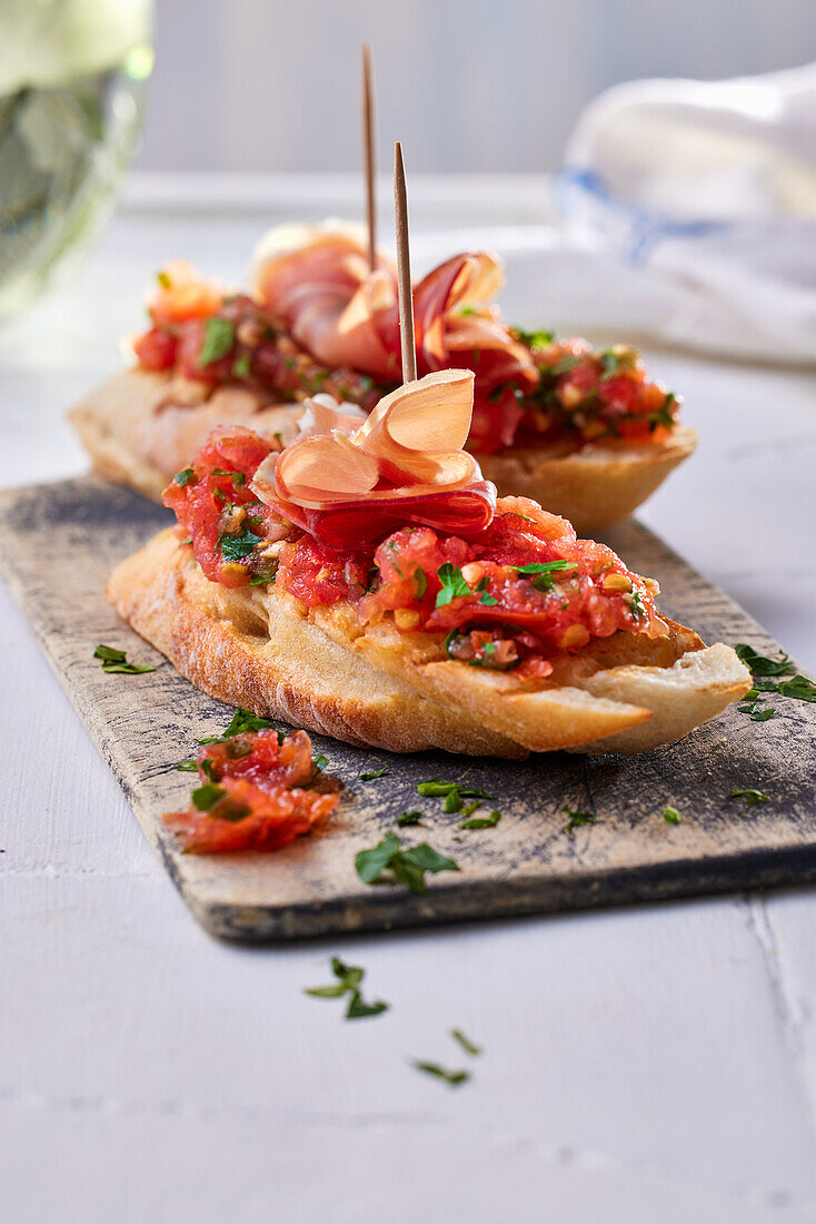 Pinchos with chopped tomatoes and Serrano ham