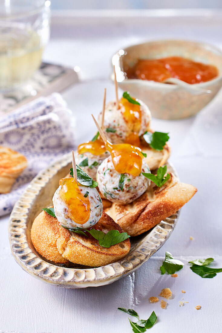 Pinchos with herb and almond goat cheese balls and jam