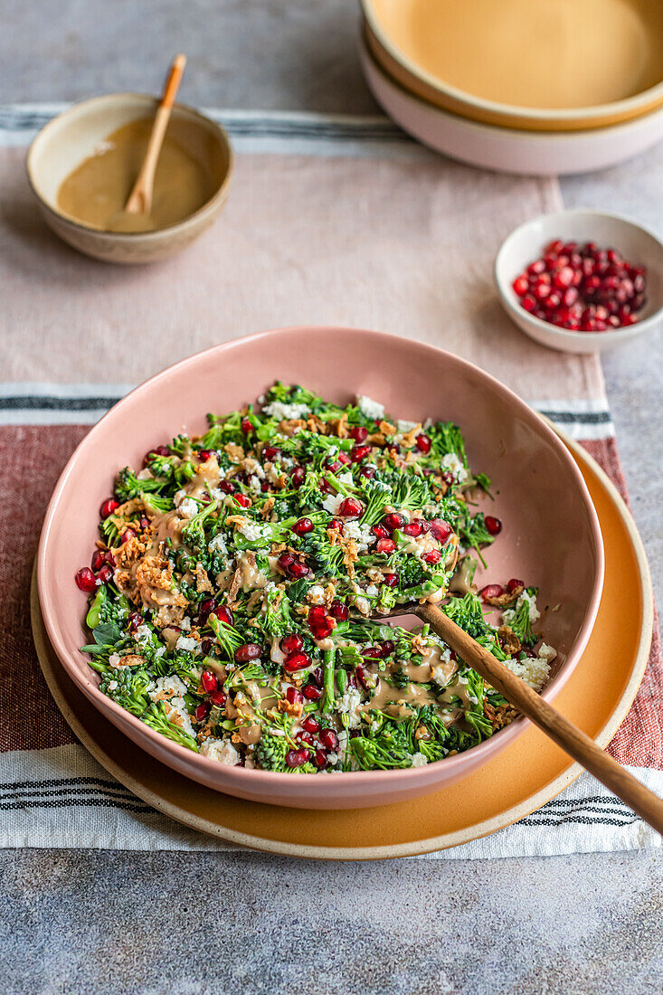 Jewelled broccoli salad with feta, pomegranate seeds and tahini dressing