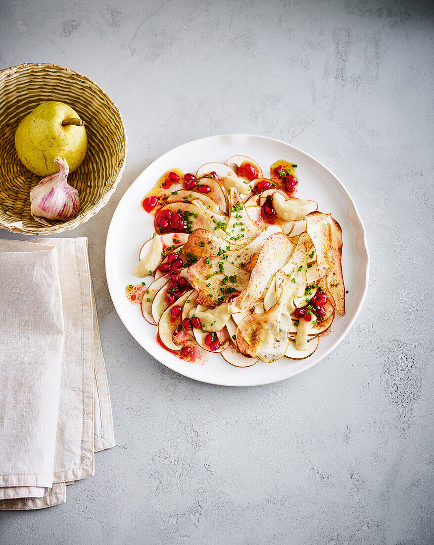 Mushroom carpaccio with cardamom pear and pomegranate dressing