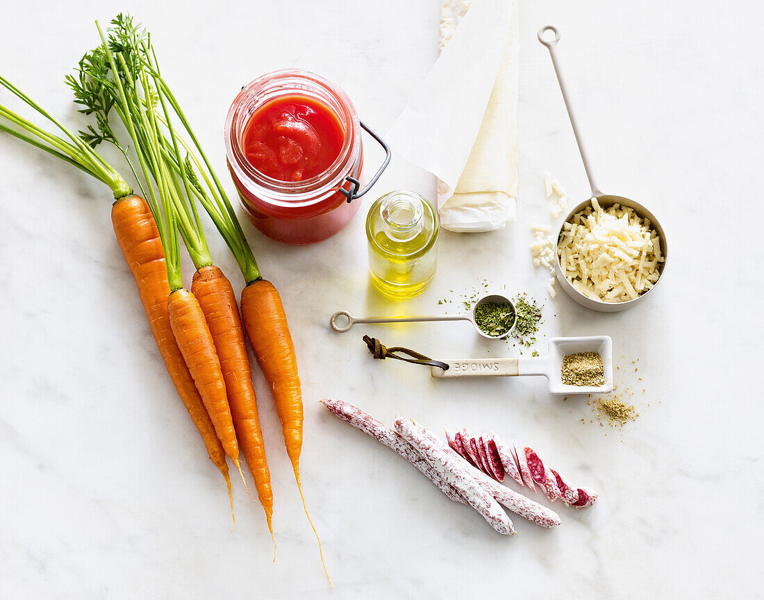 Ingredients for tarte flambée pizza with tomatoes, carrots and salami