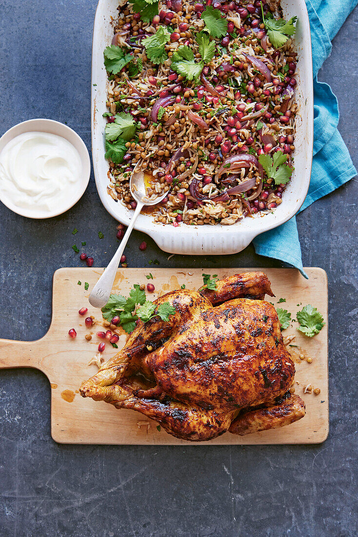 Spicy roast chicken served with rice, lentils and pomegranate seeds
