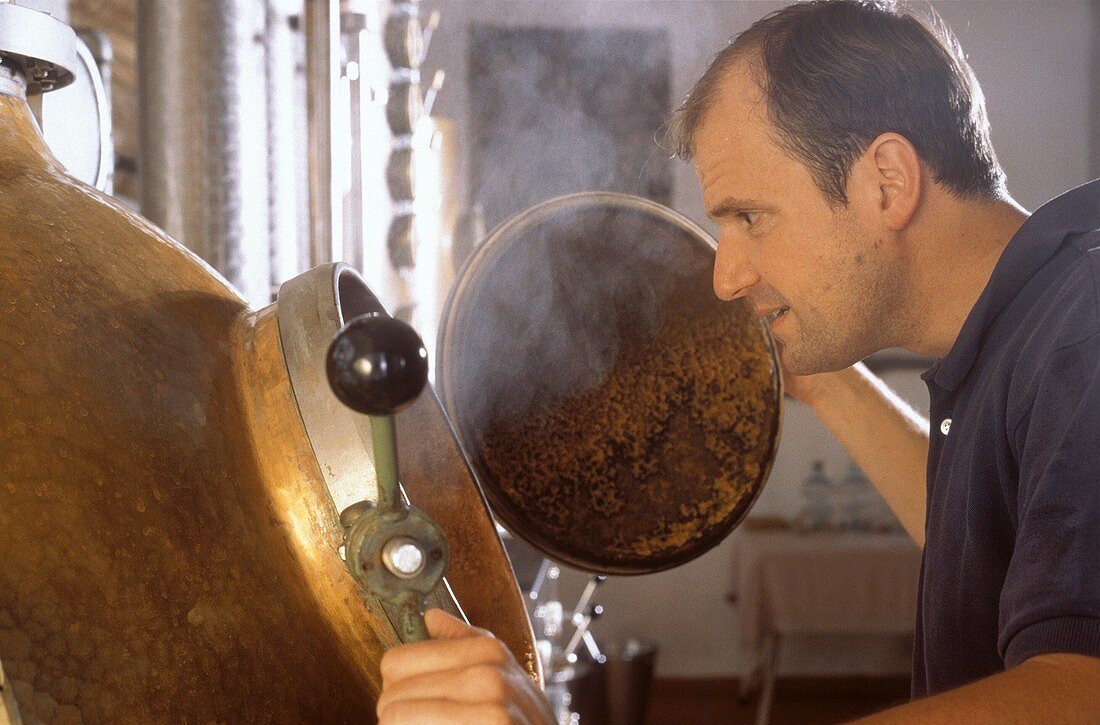 Distiller Karl Holzapfel looks into still