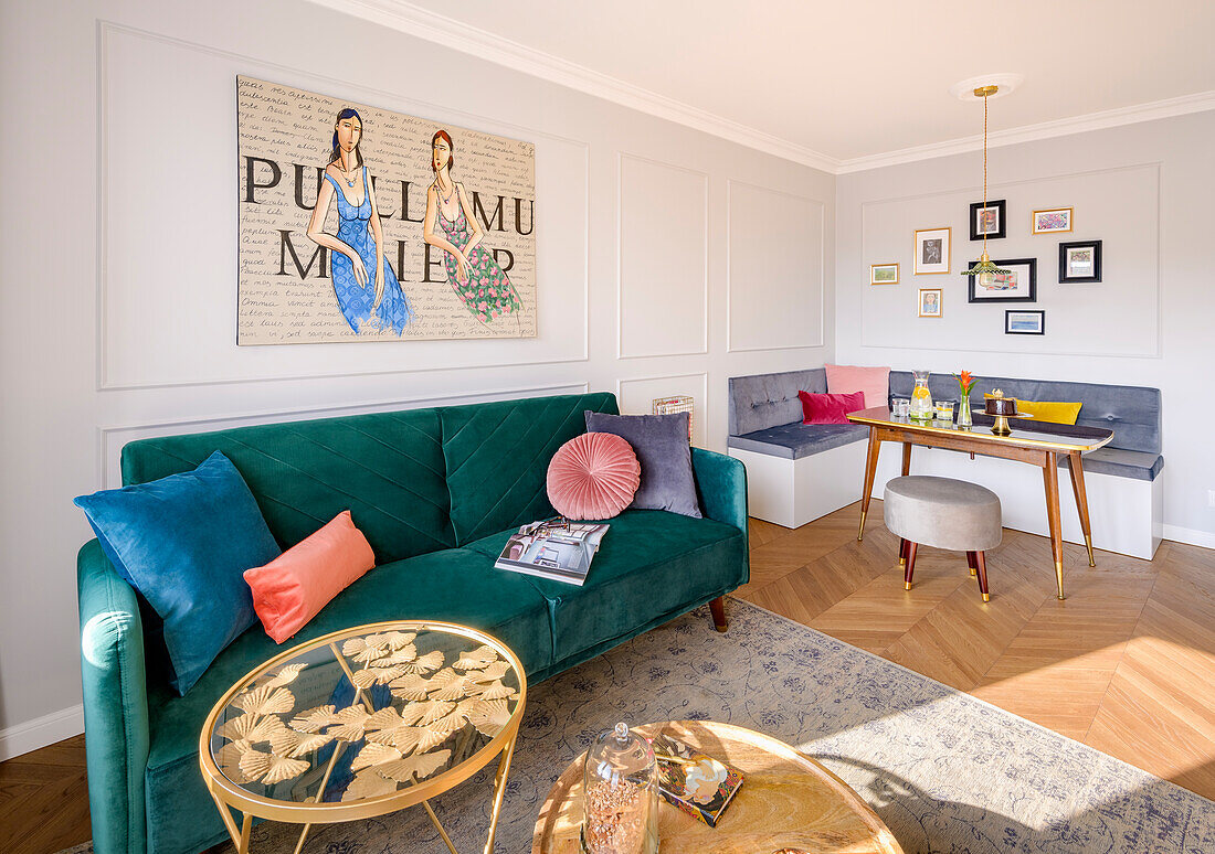 Green velvet sofa, contemporary painting above, dining area in the background