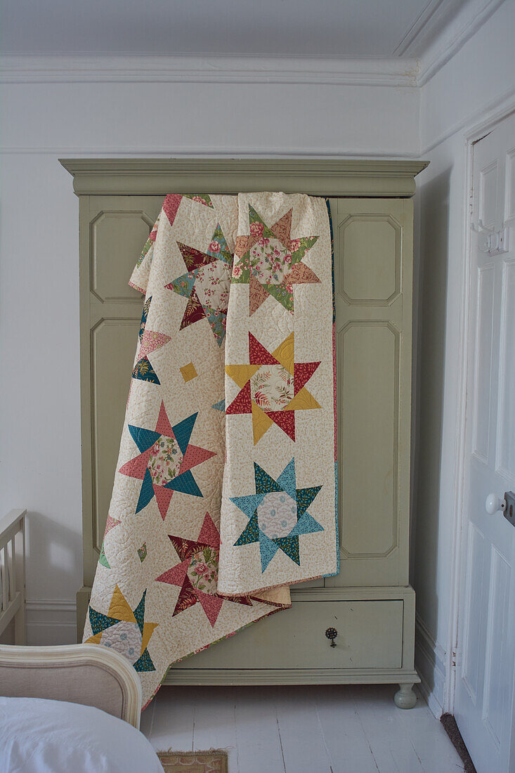 Colorful quilt on an armoire