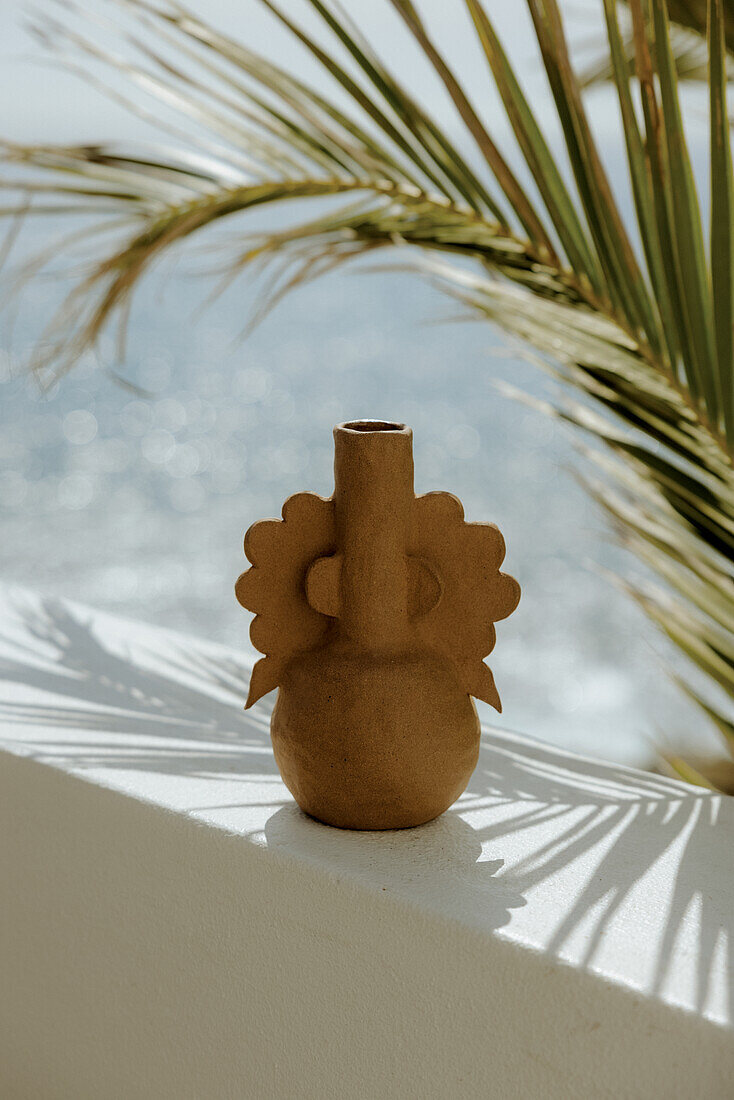 Terracotta vase on white painted parapet wall