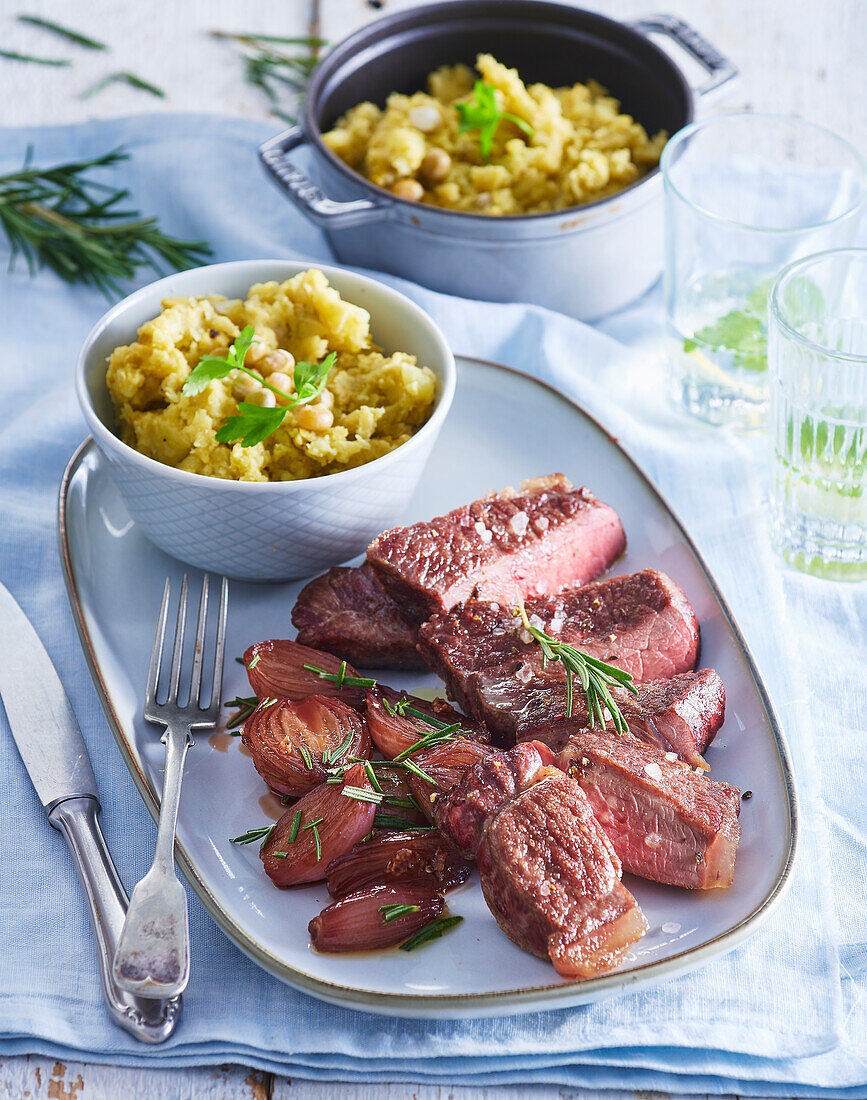 Beef sirloin steak with mashed potatoes and peas