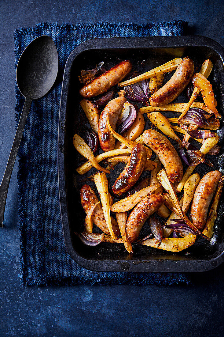 Oven roasted sausage with parsnips and red onions