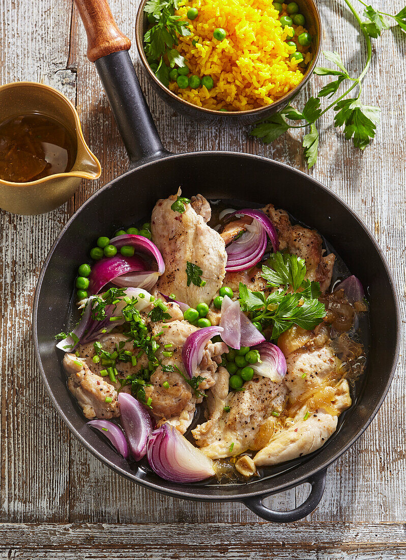 Marinated chicken breasts with saffron rice and peas