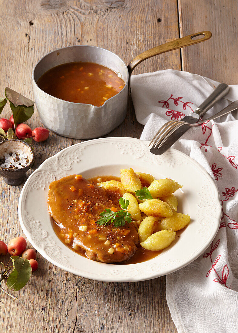 Pork neck with gingerbread sauce and semolina gnocchi