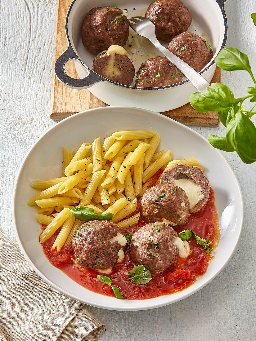 Meatballs with mozzarella filling in tomato sauce