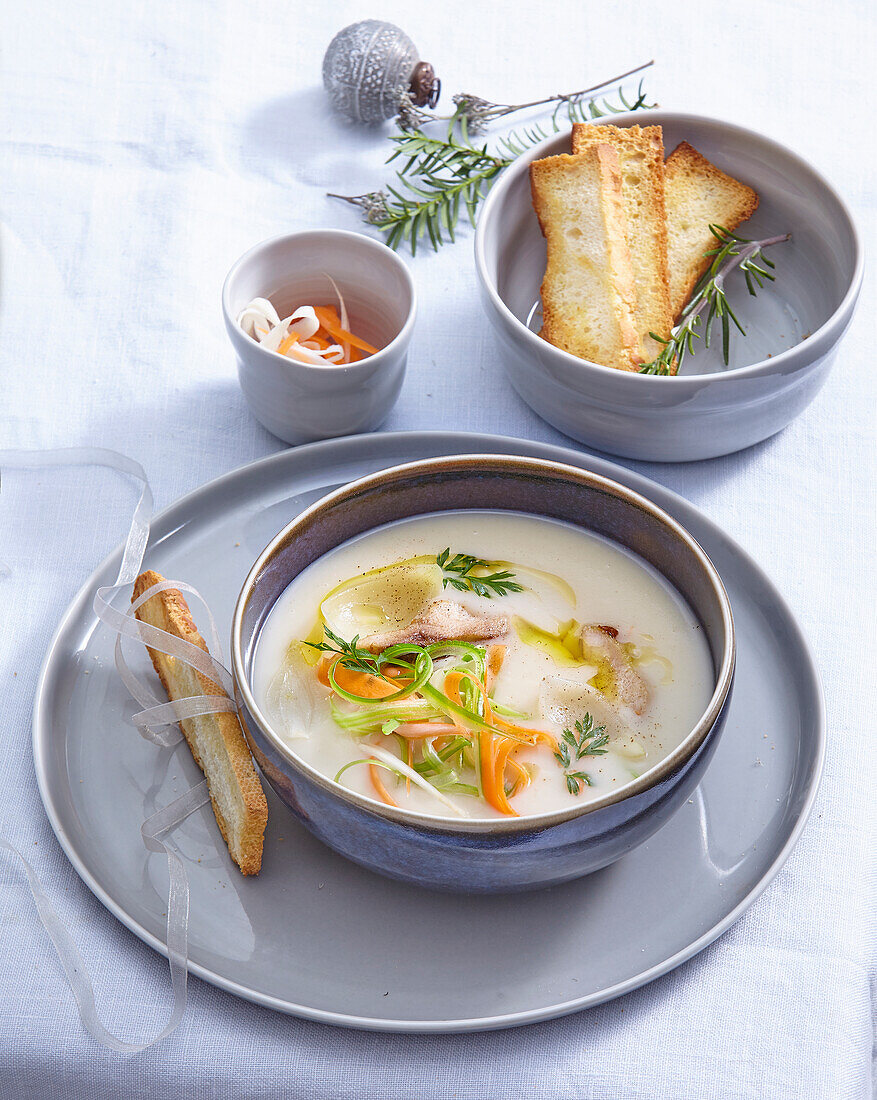 Creamy fish soup with julienne cut vegetables