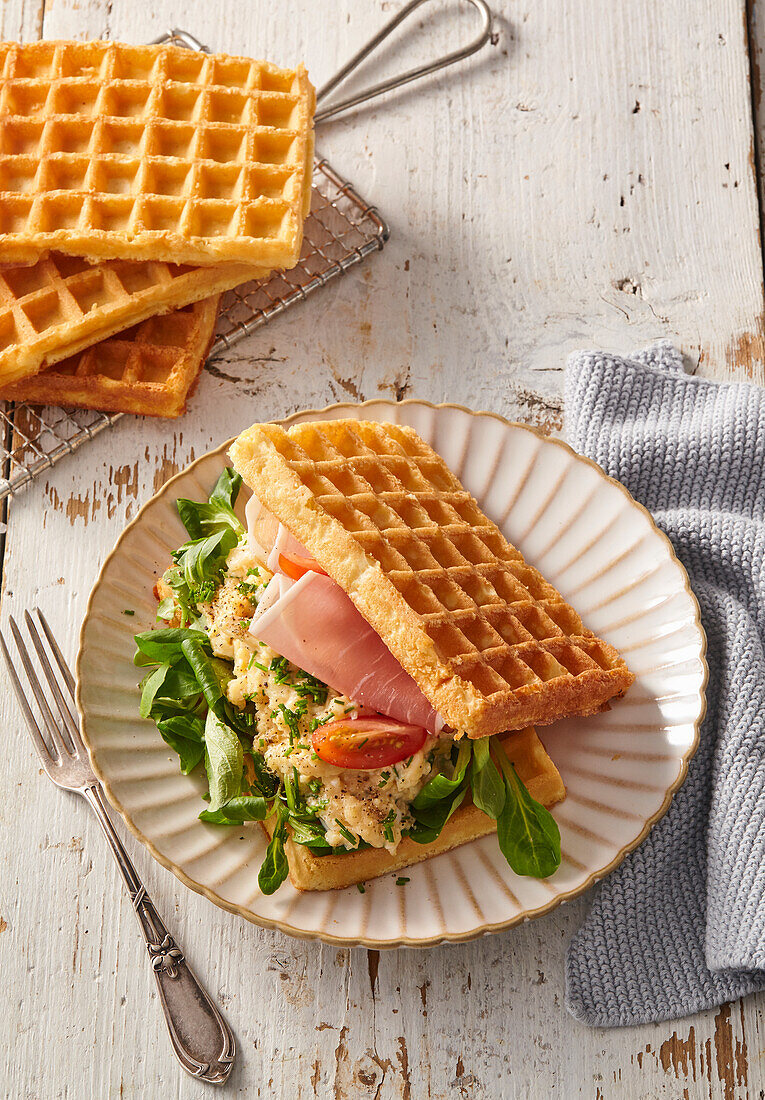 Waffle sandwich with scrambled eggs and ham