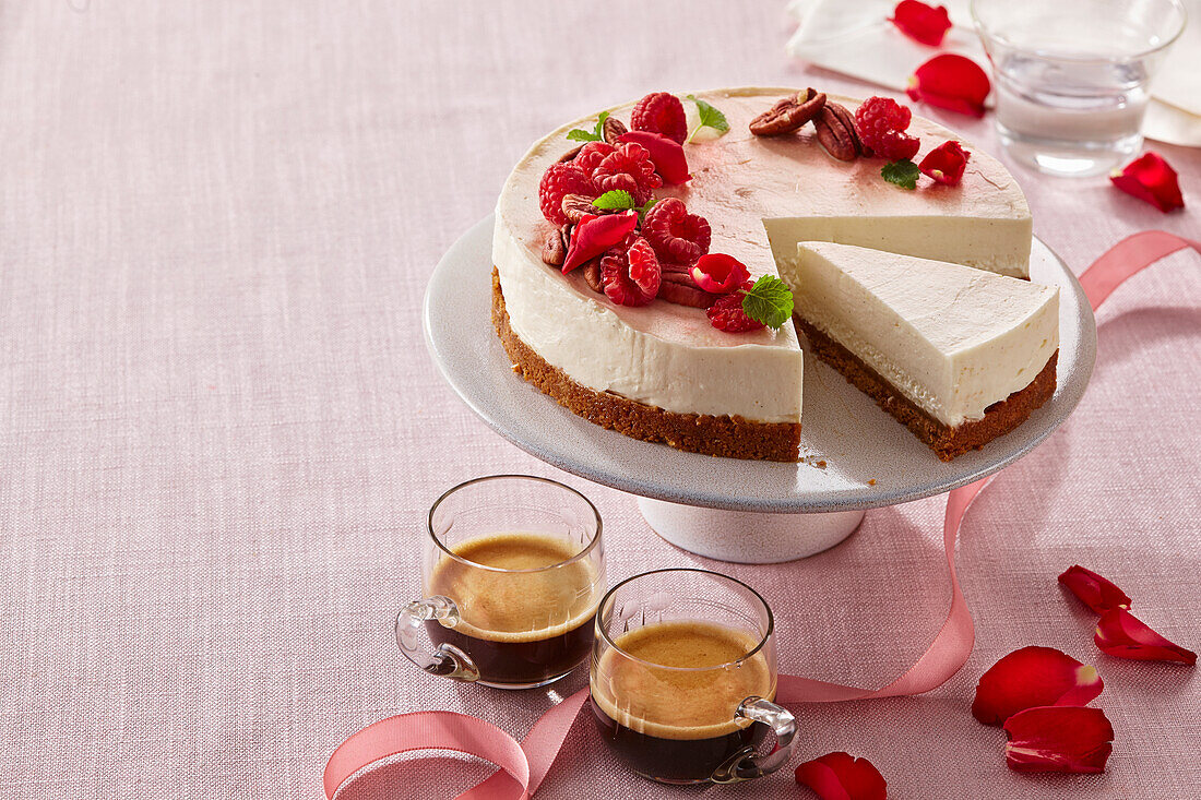 Lemon Ginger Cheesecake garnished with raspberries and rose petals