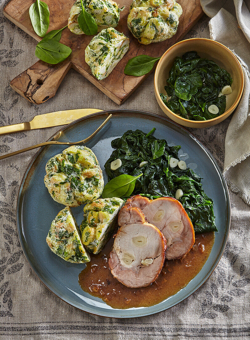 Roasted pork with spinach and herb dumplings