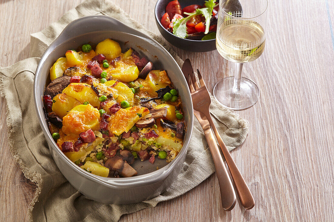 French style potato casserole with bacon, mushrooms and peas