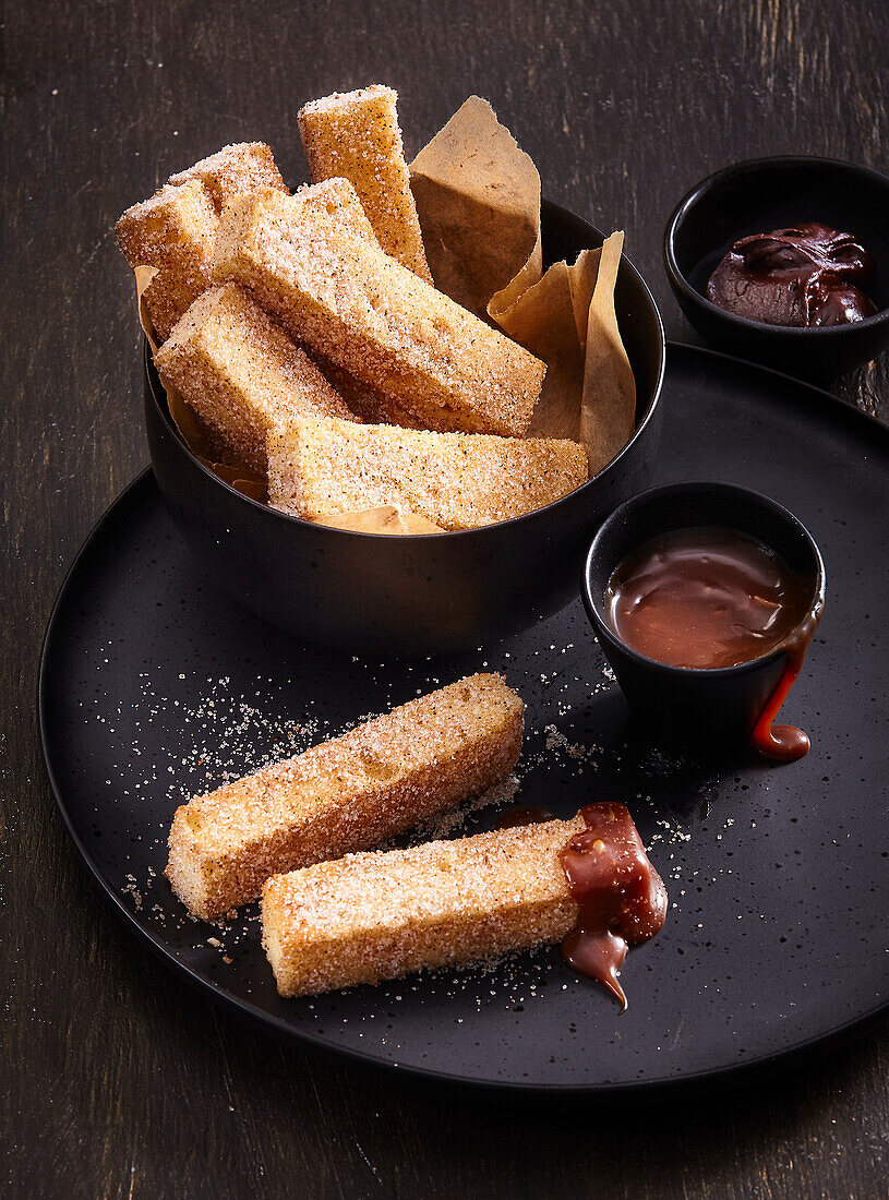 Churro sticks with chocolate and caramel for dipping